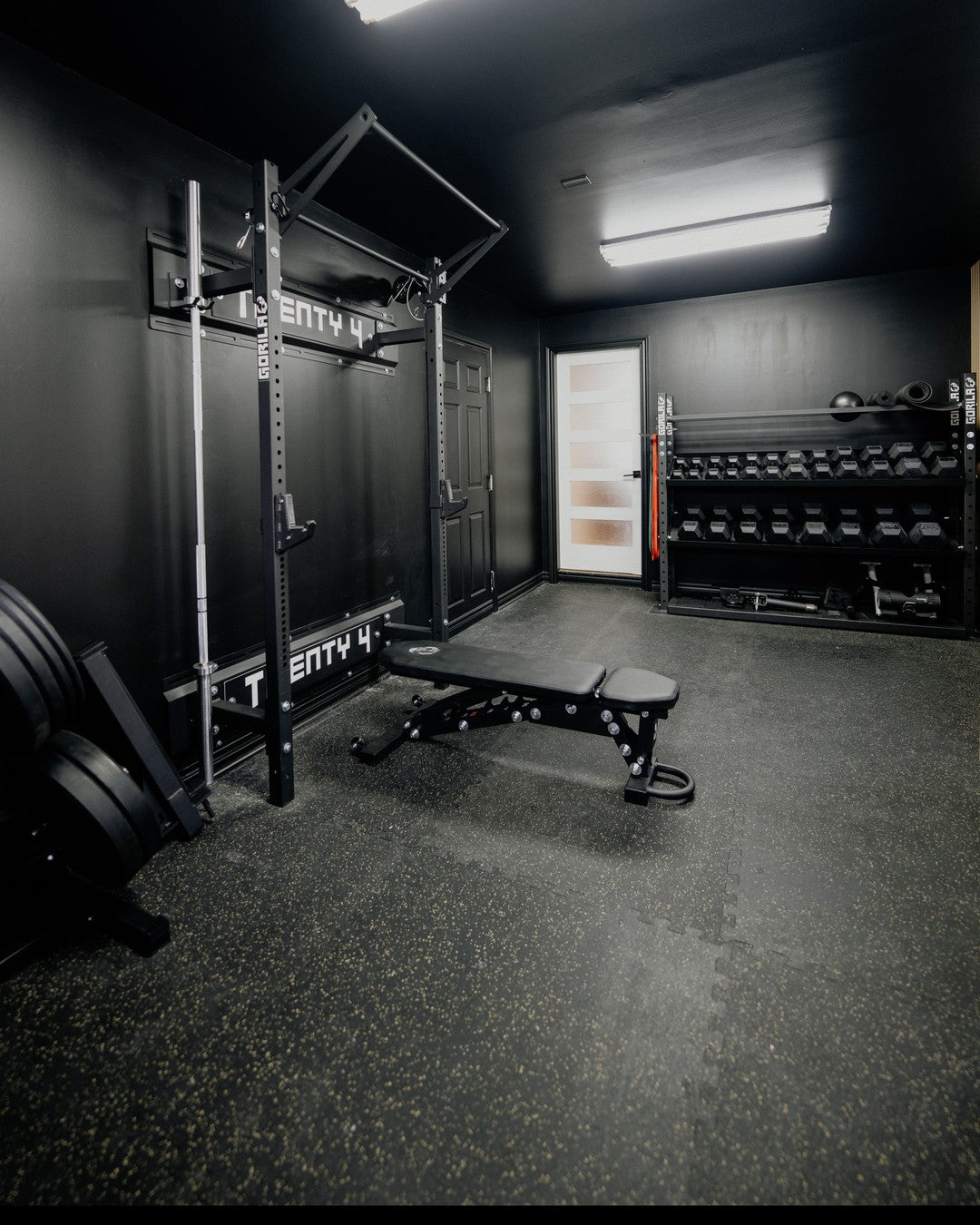 Black Home Gym on a Budget with Wall Mounted Squat Rack, Barbell, Plates and Dumbbells