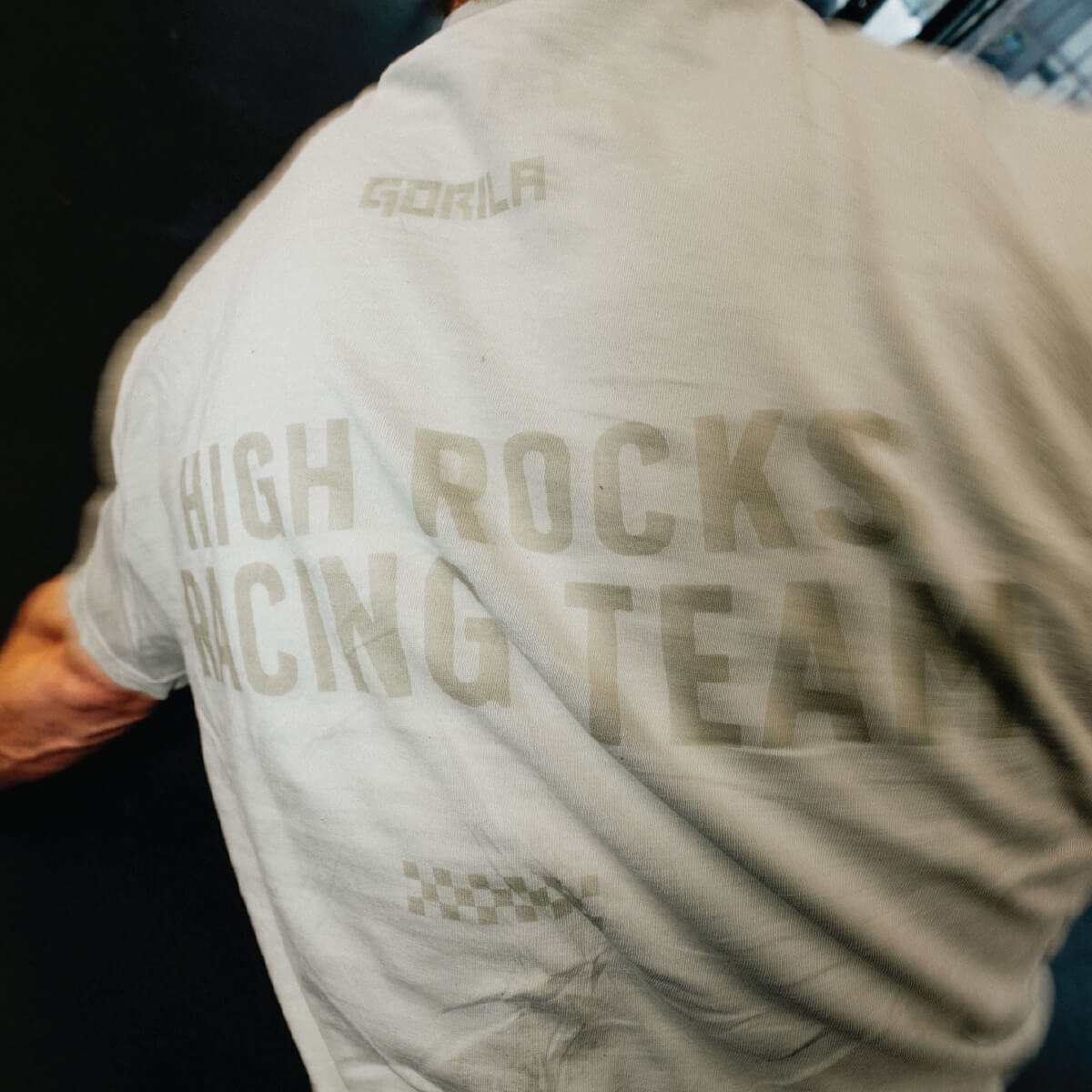Person wearing a shirt with 'High Rocks Racing Team' text on the back
