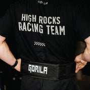 Person wearing a black t-shirt with 'High Rocks Racing Team' text and a black belt with 'Gorila' branding.