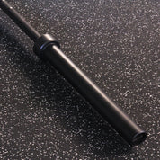 Close-up of the Gorila Men's Barbell smooth, matte black sleeve with minimal branding, designed for a seamless plate load experience.