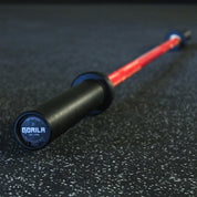 Angled shot of the 25mm red shaft barbell with precision black sleeves, optimized for CrossFit and women’s Olympic weightlifting.