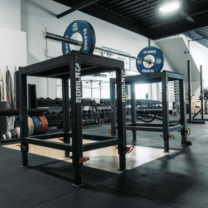 Image displaying Gorila Fitness Weightlifting Steel Jerk Blocks set up in a commercial gym environment. The blocks are positioned on a dedicated weightlifting platform, equipped with a high-quality Eleiko barbell and matching Eleiko weight plates. The sce