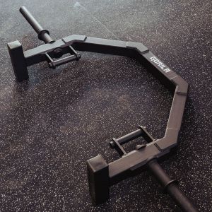 Gorila Turtle Hex Trap Bar standing vertically on the gym floor, empty, exemplifying the space-saving design and the convenience of the built-in deadlift jack.